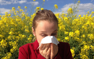 a woman with allergies sneezing