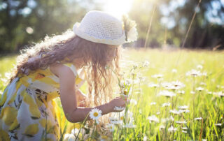 A woman with allergies in a field of flowers